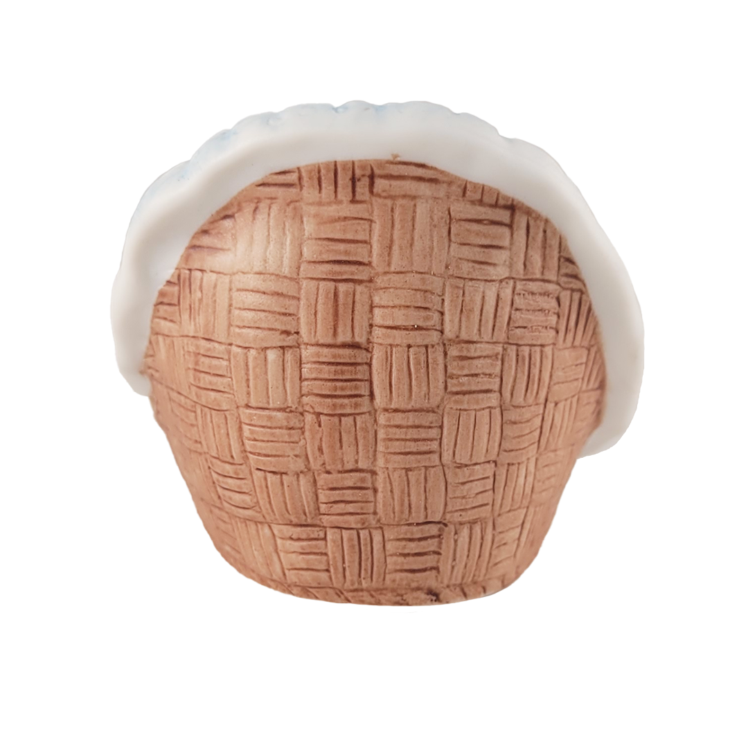 Decorative figurine with woven pattern and white rim on a white background