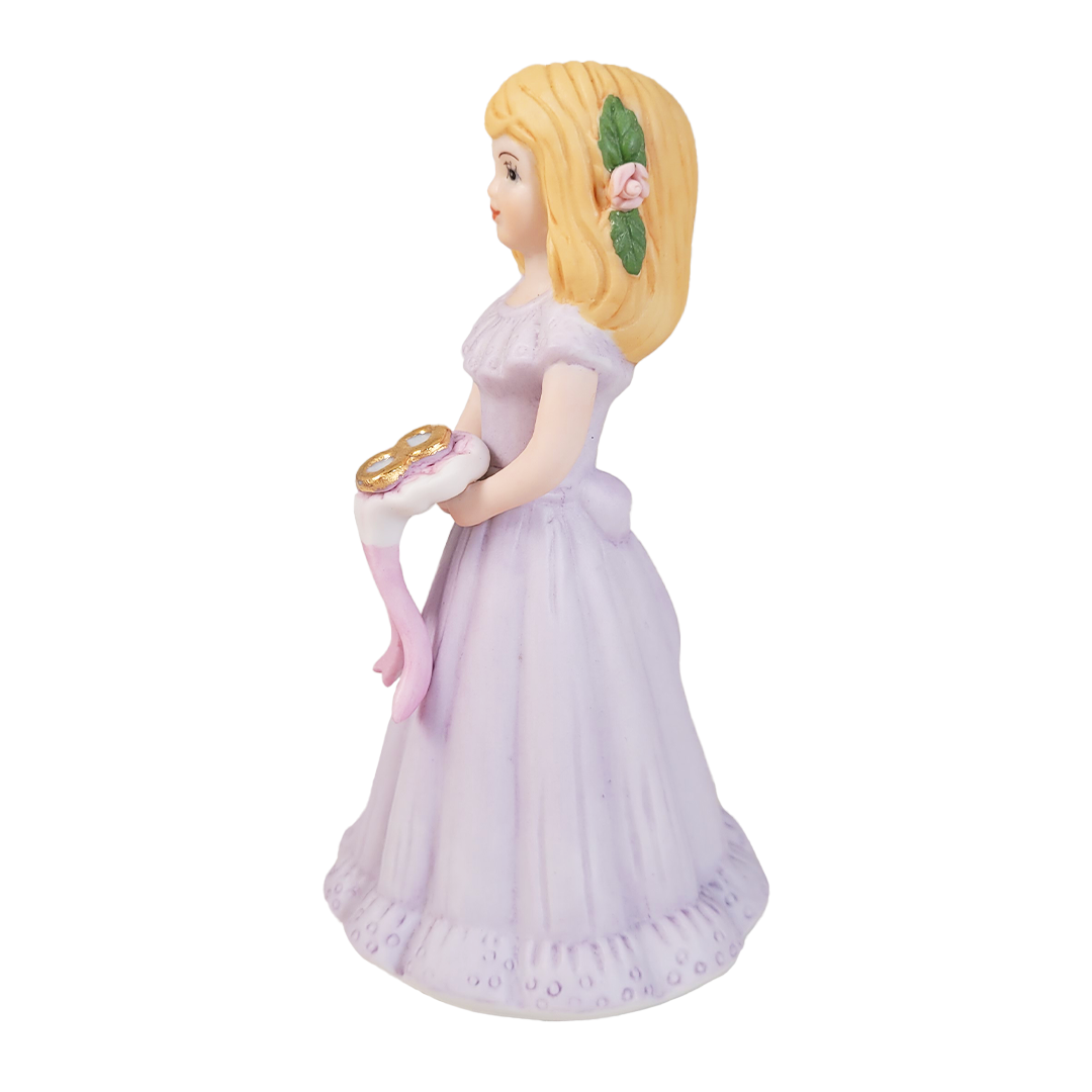 Side of figurine of a girl in a purple dress holding a bouquet with a number 8 on a white background