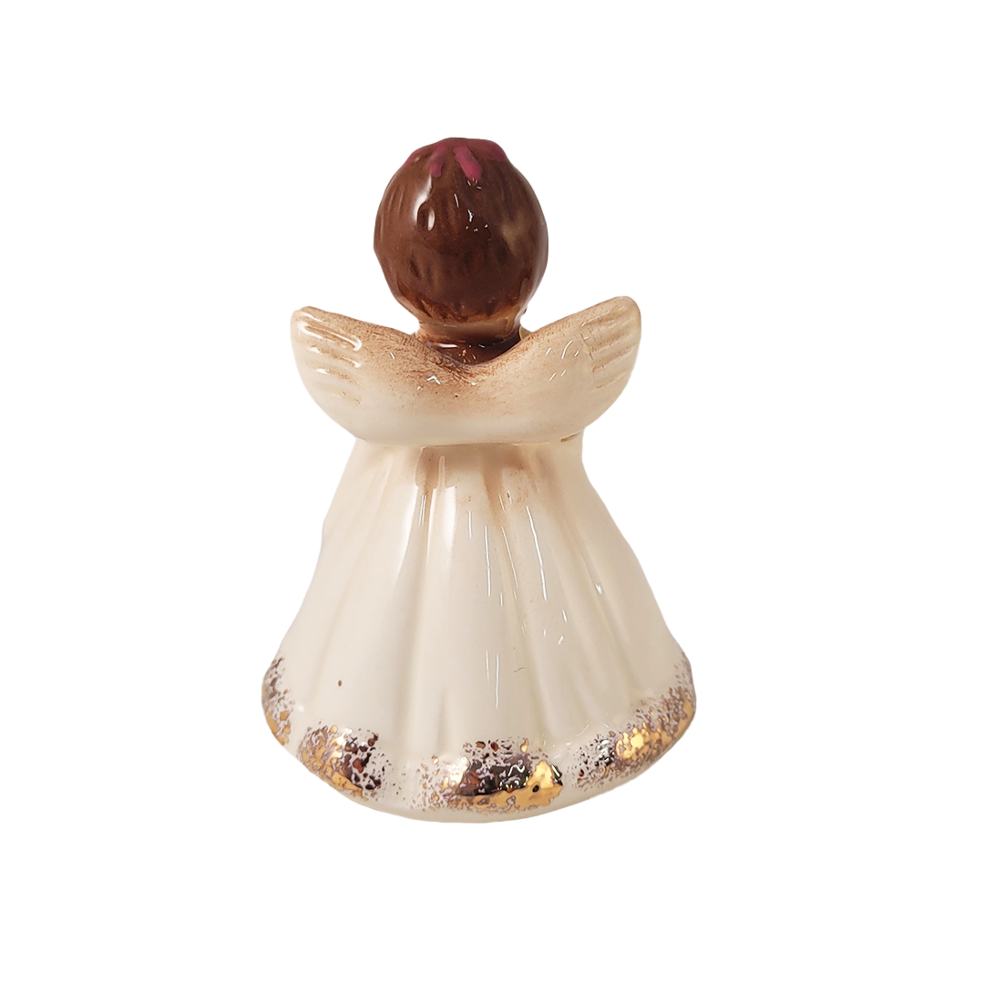 Back of decorative angel figurine with a brown head on a white background