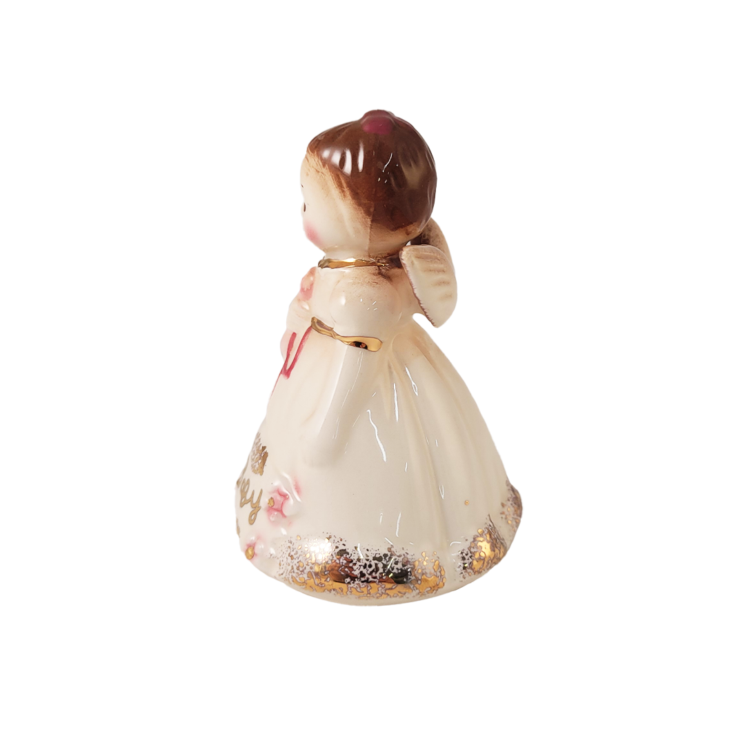 Side of small angel figurine on a white background