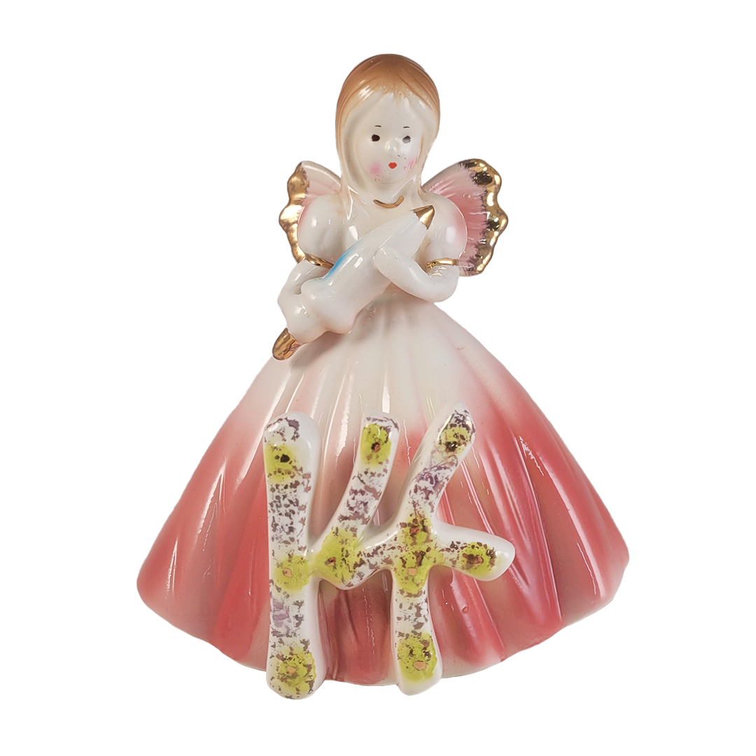 Front of angel figurine holding a parasol wearing a pink dress with a number 14 on a white background