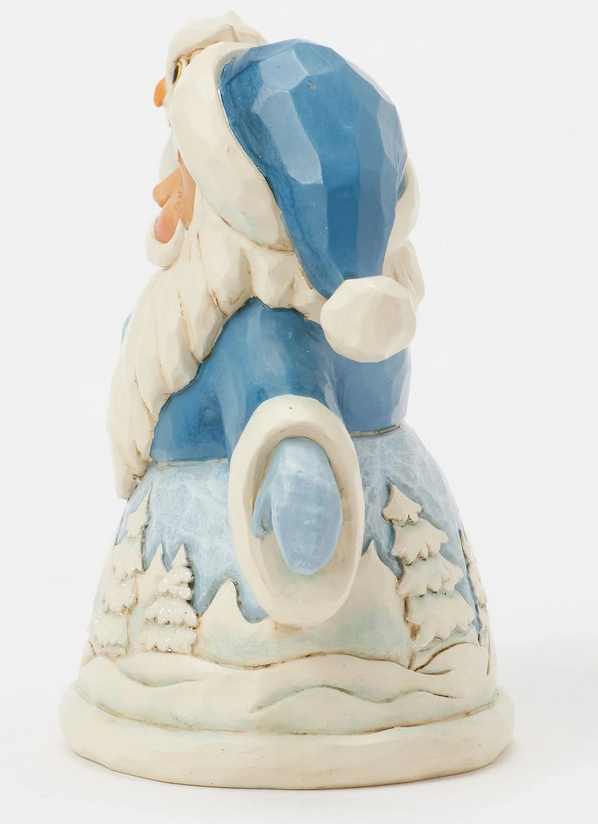 Side of decorative figurine of a Santa Claus with a snowy landscape robe.
