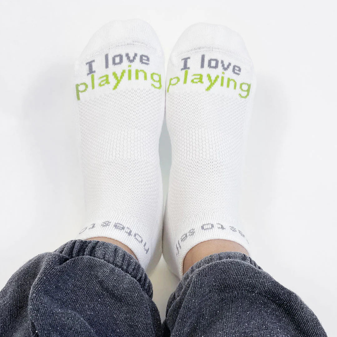 Feet wearing pickleball socks