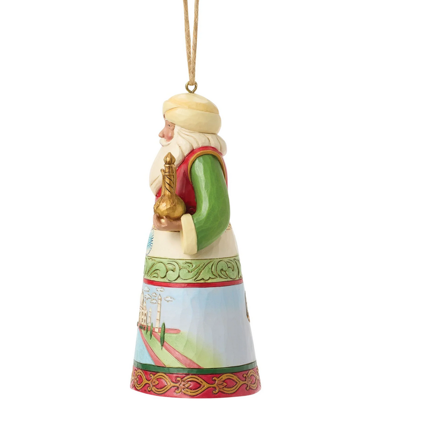 Left side of decorative ornament of a Santa with a colorful outfit featuring Indian culture on a white background