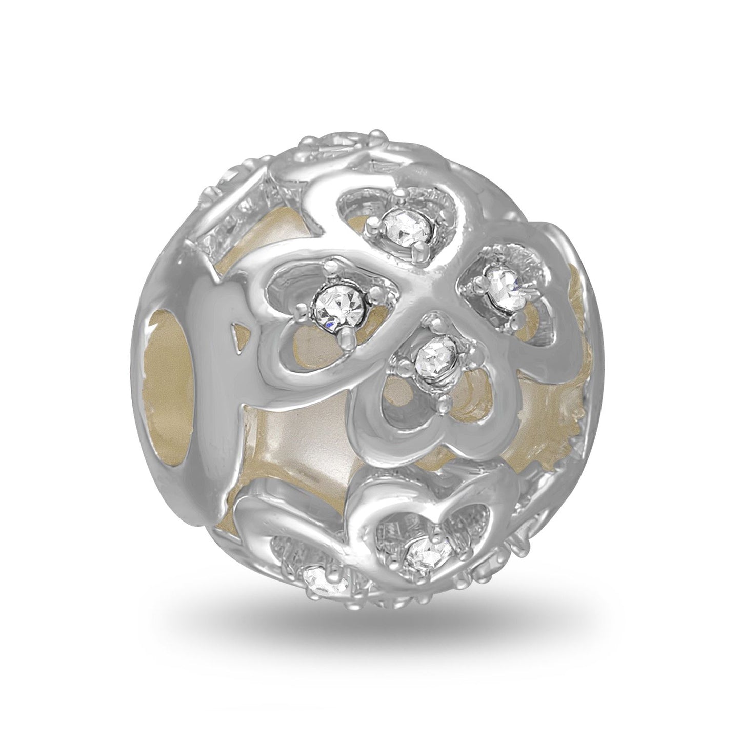 A silver-colored metal bead with a four leaf clover cut out framing a pearlescent background