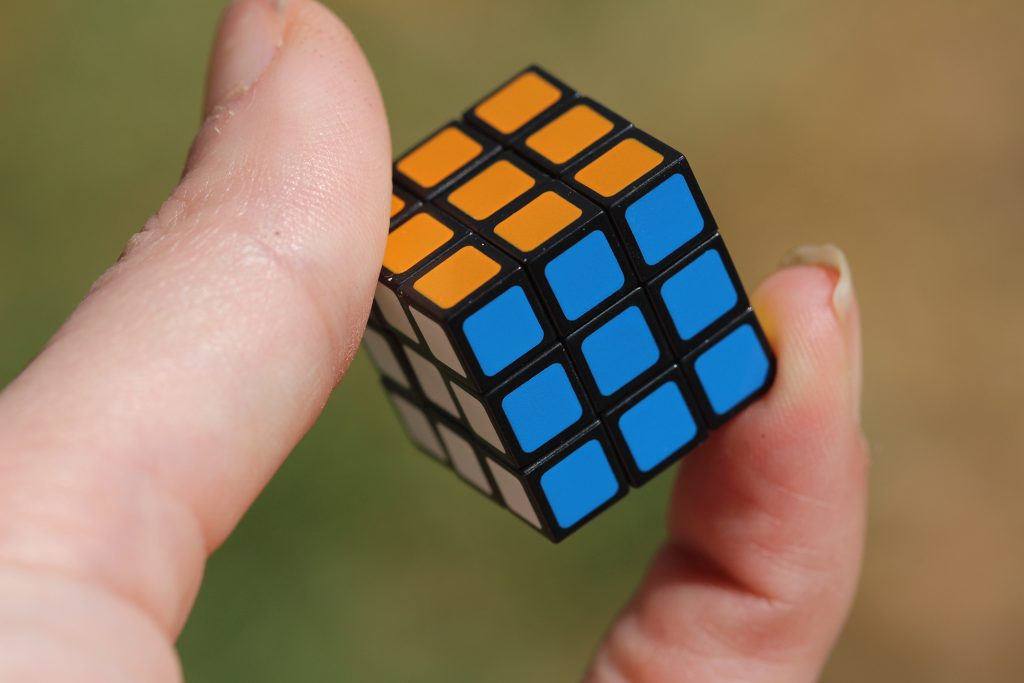 fingers hold rubik's cube