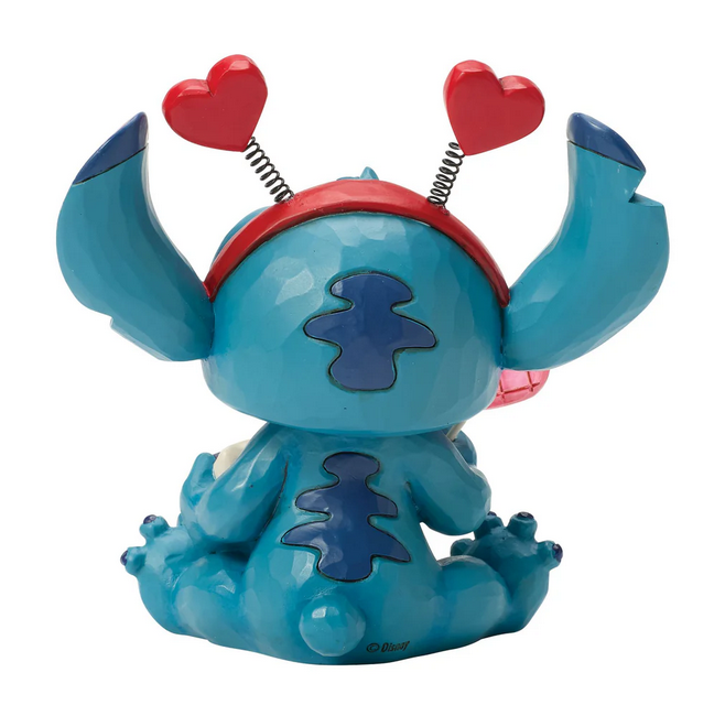 Back of Stitch figurine with a red heart headband on a white background