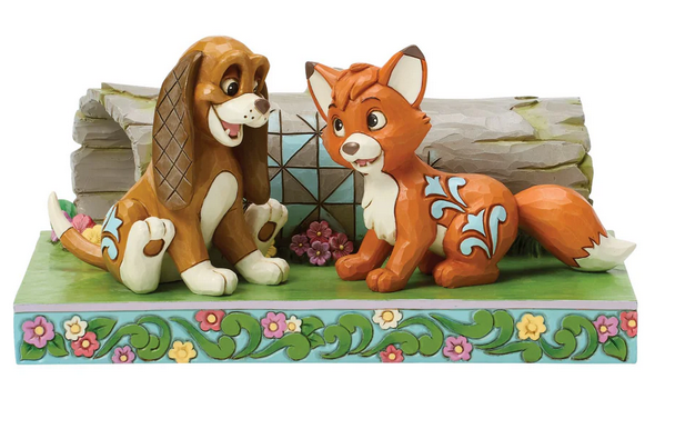 Front of figurine of Tod and Copper from The Fox and the Hound on a decorative base on a white background