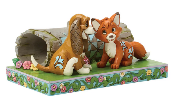 Side of figurine of Tod and Copper in front of a log on a decorative base on a white background.