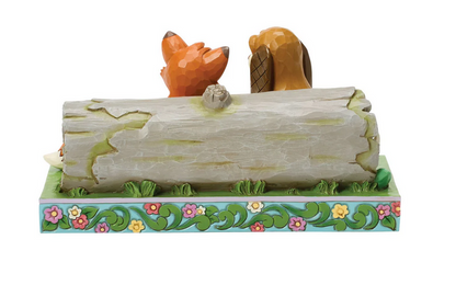 Decorative figurine of Tod and Copper on a log with a floral base