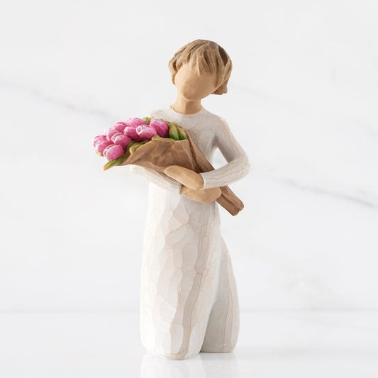 Figurine holding flowers front view