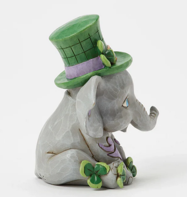 Elephant figurine wearing a green top hat on a white background
