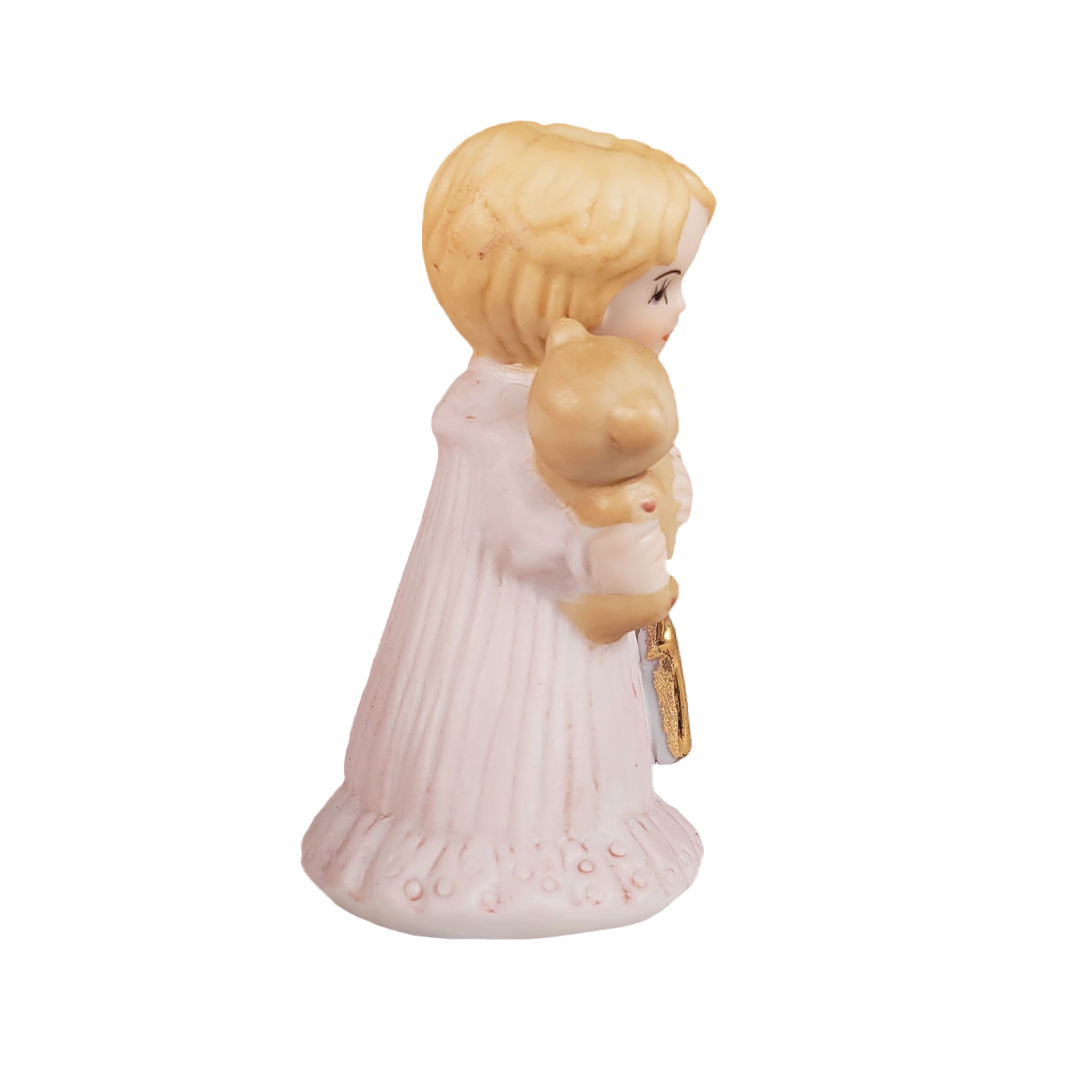 side of figurine of a woman holding a baby with a key, on a white background