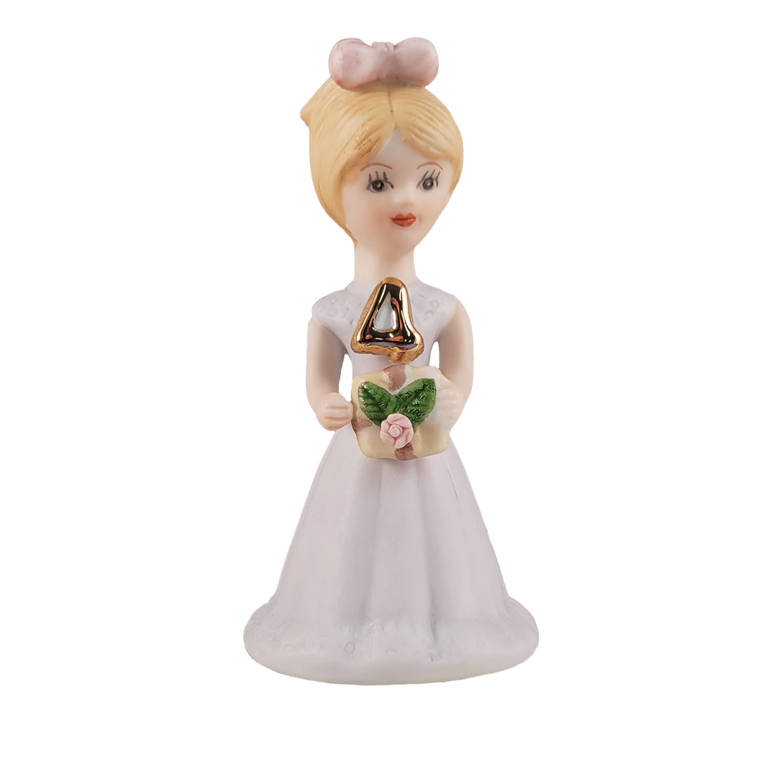 Front of figurine of a woman in a white dress with blonde hair on a white background