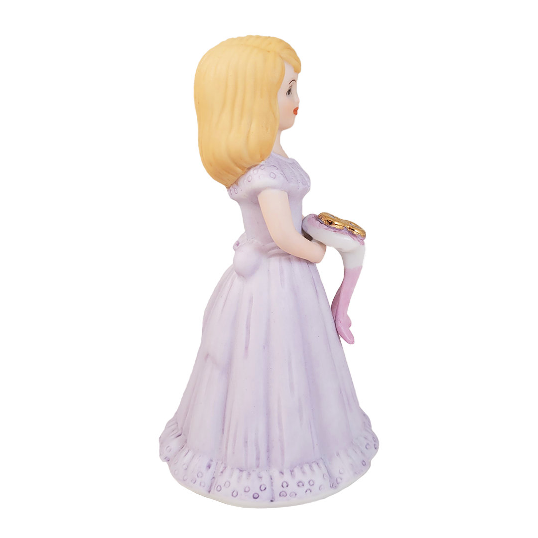 Side of figurine of a girl in a purple dress holding a bouquet with a number 8 on a white background
