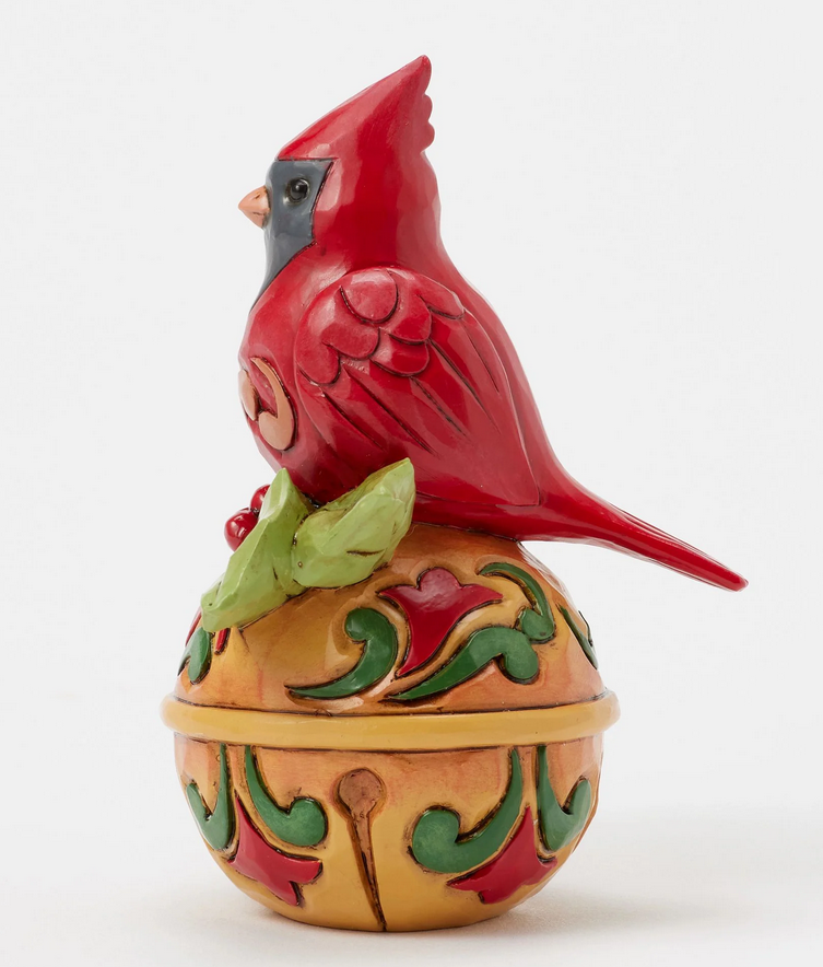 Left side of decorative cardinal figurine on bell a white background