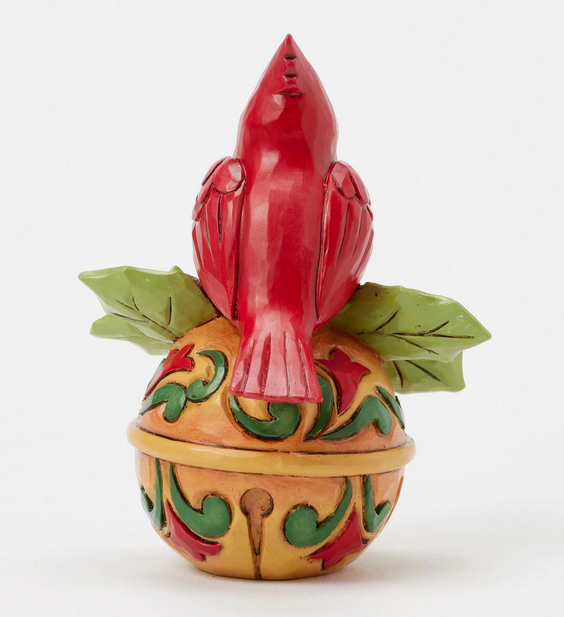 Back of decorative cardinal figurine on bell a white background