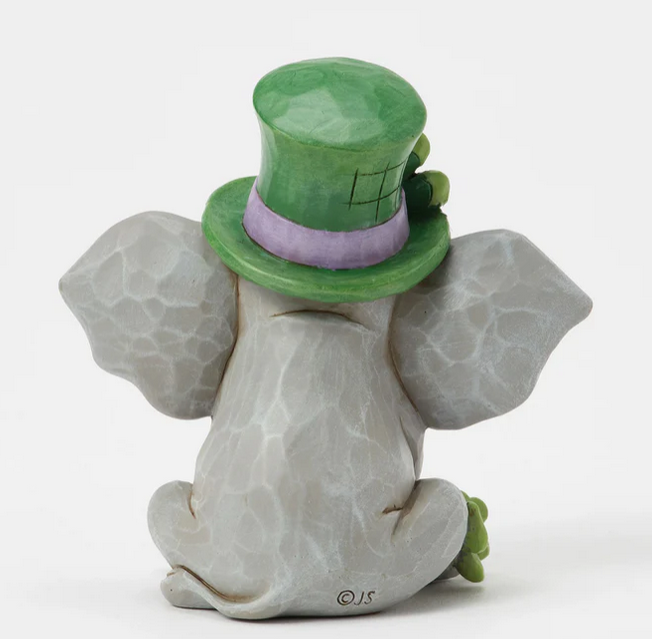 Back of elephant figurine wearing a green top hat on a white background