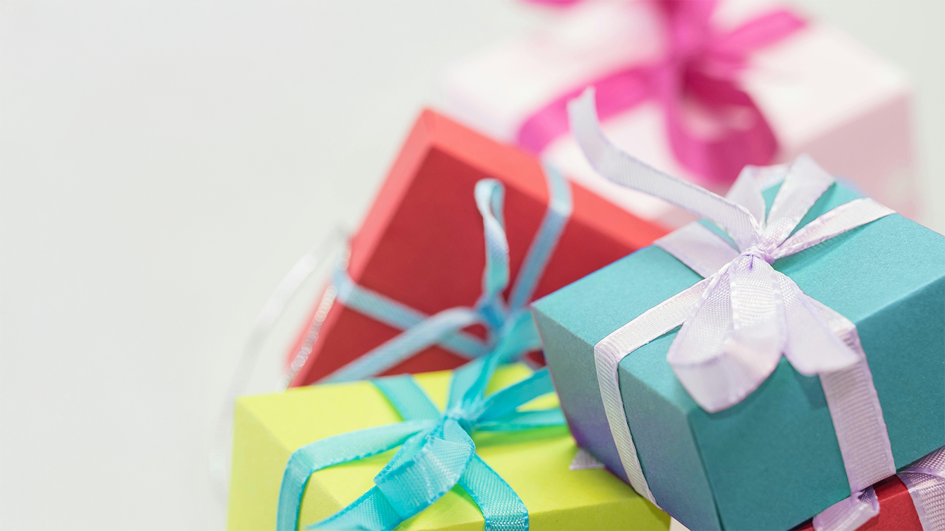 Colorful gift boxes with ribbons on a light background