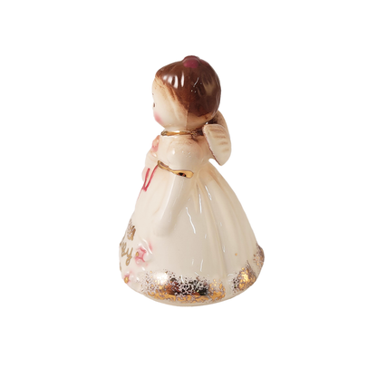 Side of small angel figurine on a white background