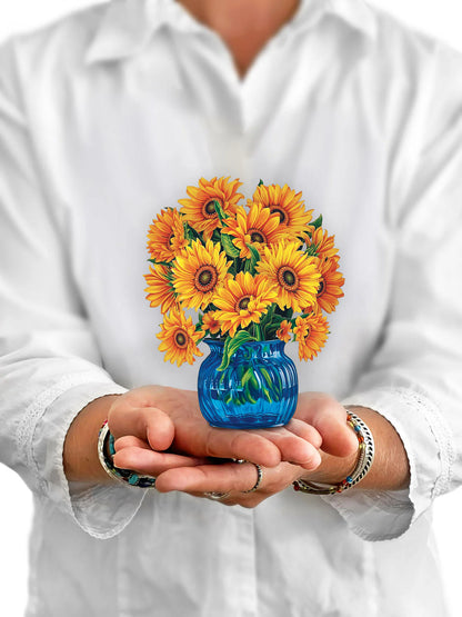 Person holding sunflower pop up flowers