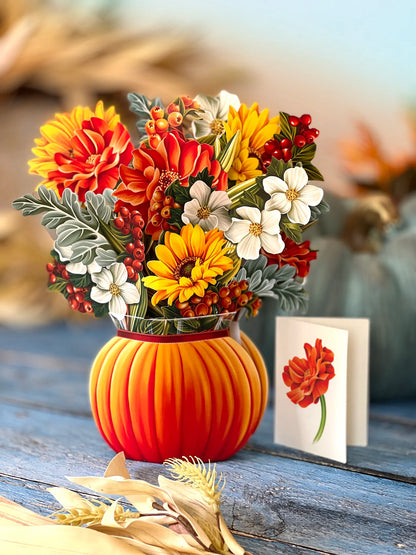 pumpkin pop up bouquet on table with card