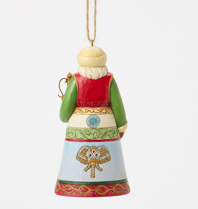 Back of decorative ornament of a Santa with a colorful outfit featuring Indian culture on a white background