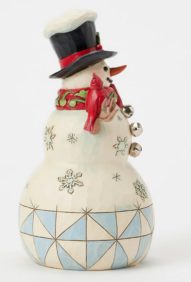 Decorative snowman figurine with geometric patterns and a cardinal - side view