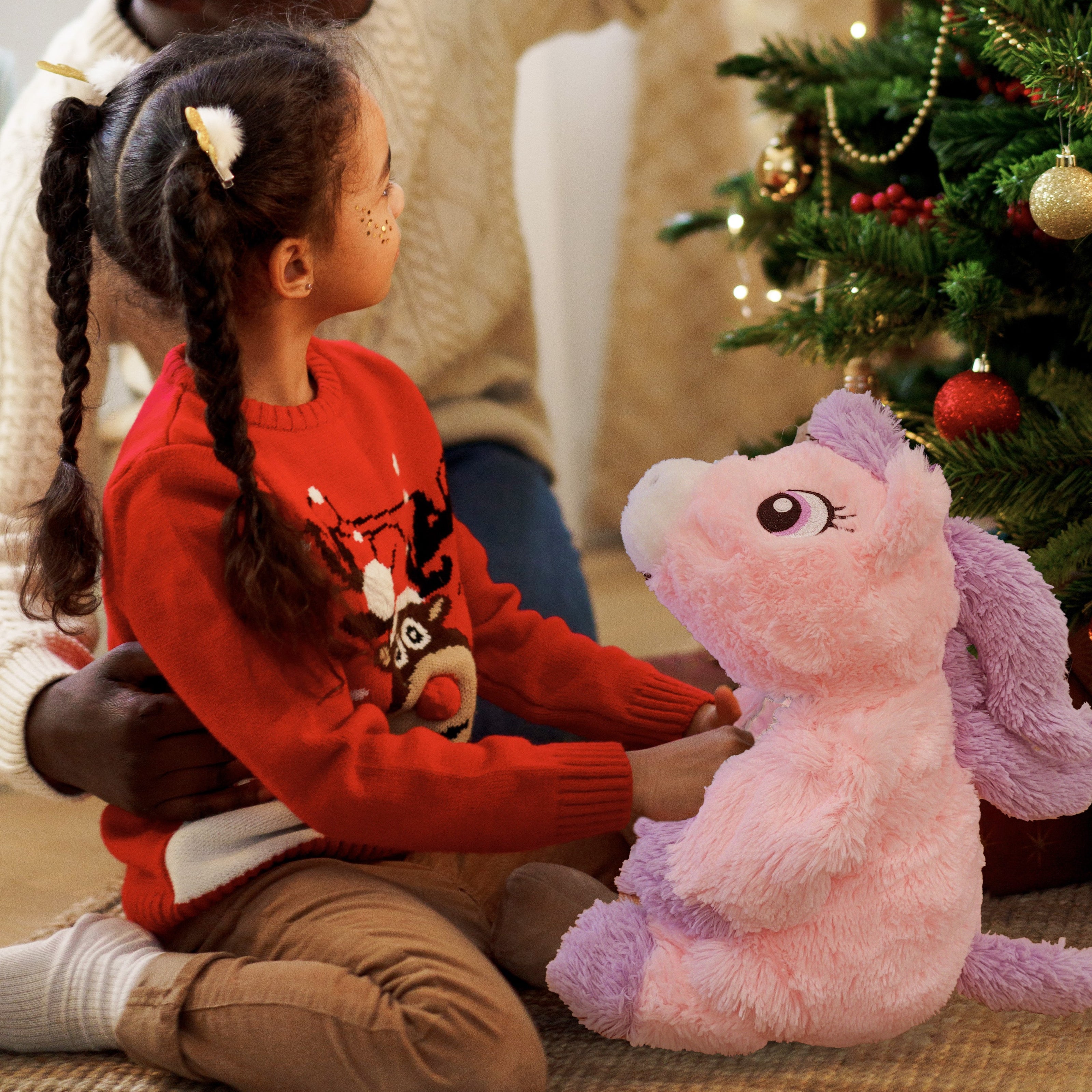 child holding unicorn plush