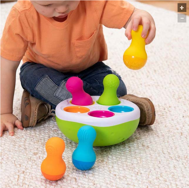 child playing with spinny pins