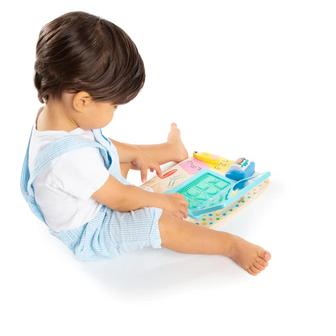 kid playing with activity board